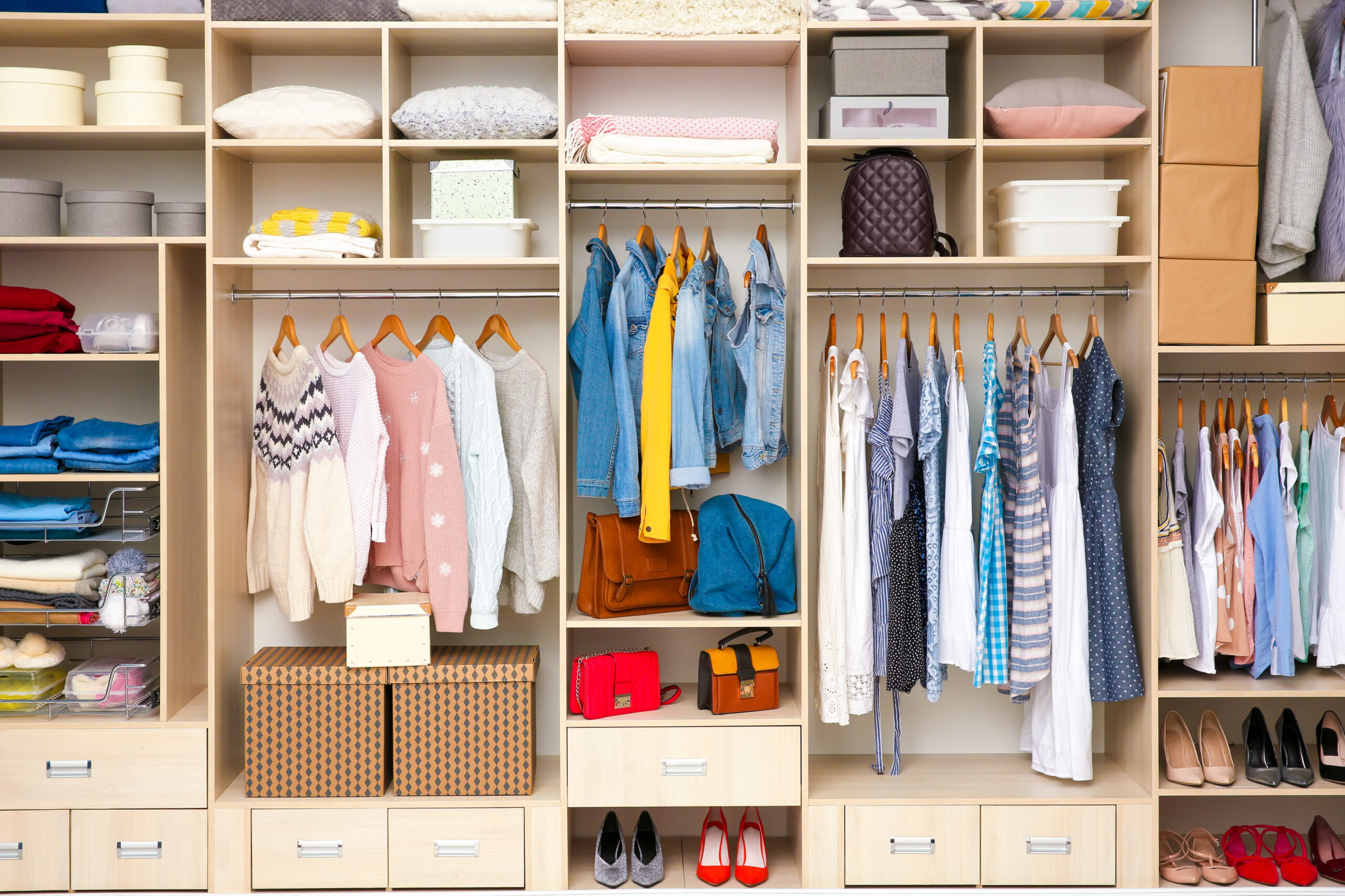 a clean, organized walk in closet. Closet Organization products concept image.